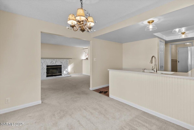 2731 Wabash Cir, Sparks, NV 89434 - kitchen with carpet, baseboards, a chandelier, a fireplace, and decorative light fixtures