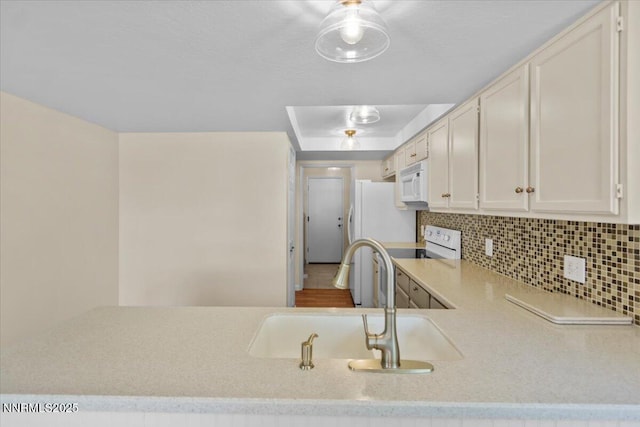 2731 Wabash Cir, Sparks, NV 89434 - kitchen with white appliances, a sink, light countertops, backsplash, and white cabinetry
