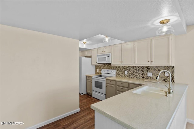 2731 Wabash Cir, Sparks, NV 89434 - kitchen featuring white appliances, a sink, tasteful backsplash, dark wood-style flooring, and a peninsula