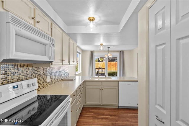 2731 Wabash Cir, Sparks, NV 89434 - kitchen with white appliances, a sink, dark wood-style floors, tasteful backsplash, and a chandelier