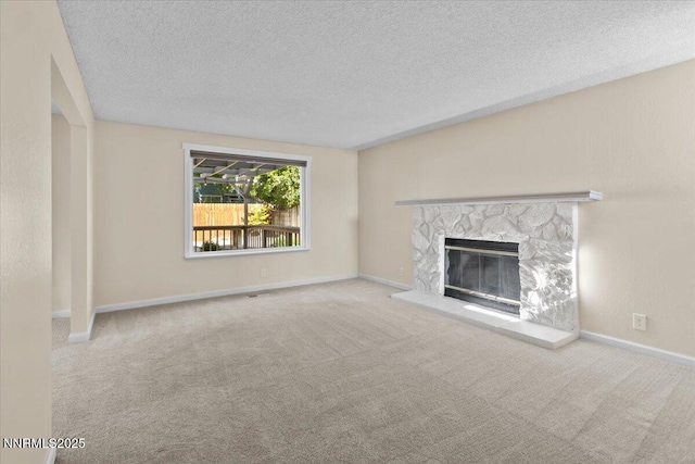 2731 Wabash Cir, Sparks, NV 89434 - unfurnished living room with a textured ceiling, carpet, a stone fireplace, and baseboards