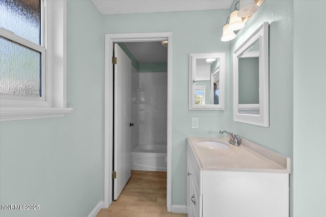 2731 Wabash Cir, Sparks, NV 89434 - full bathroom featuring vanity, wood finished floors, plenty of natural light, and baseboards
