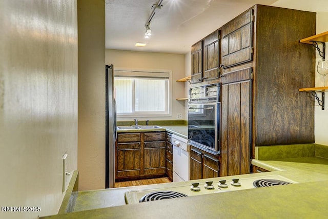 710 Tina Ct # B-2, Stateline, NV 89449 - kitchen featuring open shelves, wall oven, dishwasher, rail lighting, and cooktop