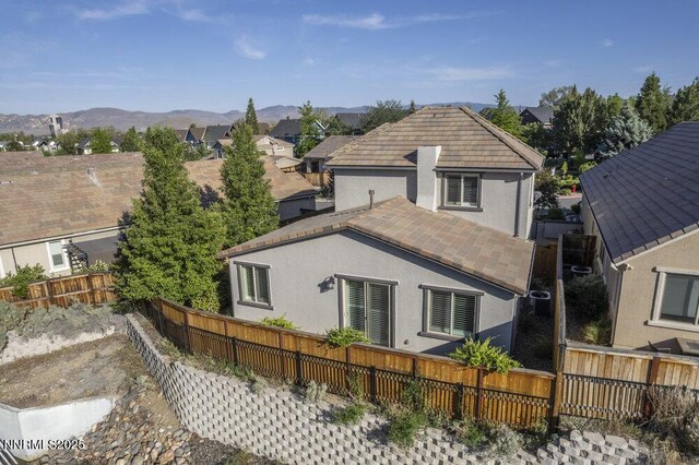1385 Balfour Dr, Reno, NV 89509 - rear view of property with stucco siding, a fenced backyard, and a mountain view
