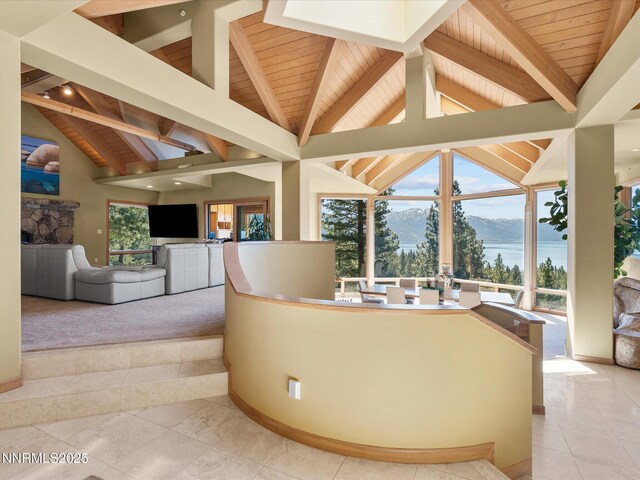563 Knotty Pine Dr, Incline Village, NV 89451 - sunken living room featuring wooden ceiling, a stone fireplace, light carpet, and baseboards