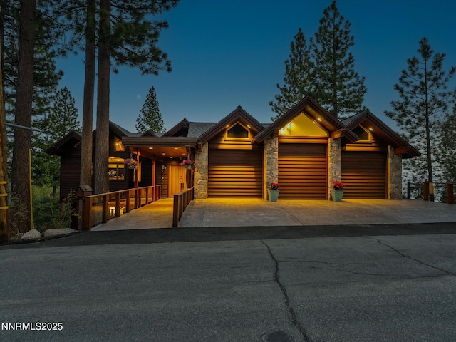 563 Knotty Pine Dr, Incline Village, NV 89451 - view of front of house with stone siding, a garage, and driveway