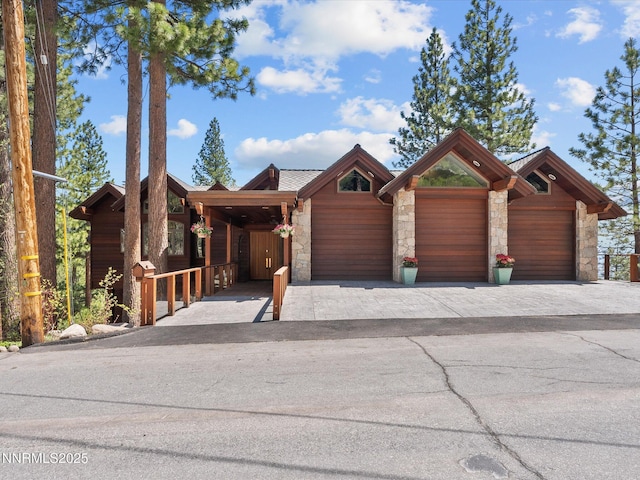 563 Knotty Pine Dr, Incline Village, NV 89451 - view of front facade featuring stone siding, a garage, and decorative driveway