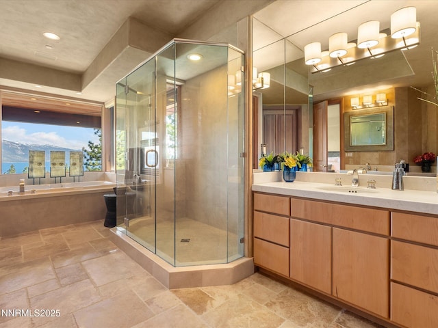 563 Knotty Pine Dr, Incline Village, NV 89451 - bathroom with vanity, a garden tub, stone tile flooring, a shower stall, and recessed lighting