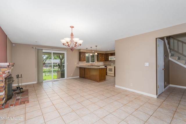 3164 Clan Alpine Dr, Sparks, NV 89434 - kitchen featuring white appliances, a peninsula, a chandelier, open floor plan, and a brick fireplace