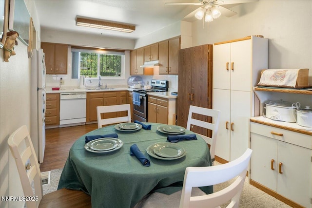 110 Smithridge Park, Reno, NV 89502 - kitchen with white appliances, under cabinet range hood, a sink, a ceiling fan, and light countertops