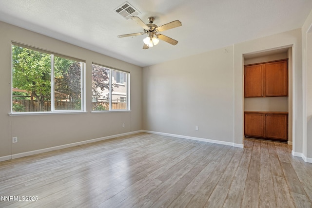 7121 Jermann Dr, Sparks, NV 89436 - unfurnished room with healthy amount of natural light, light wood-style flooring, and a ceiling fan