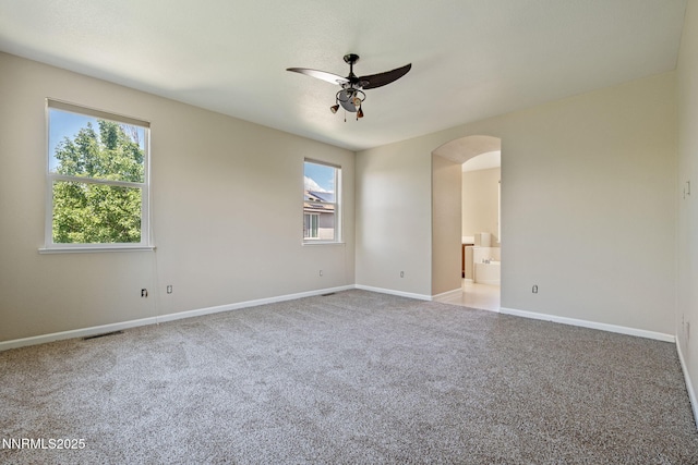 7121 Jermann Dr, Sparks, NV 89436 - carpeted empty room with a ceiling fan and arched walkways