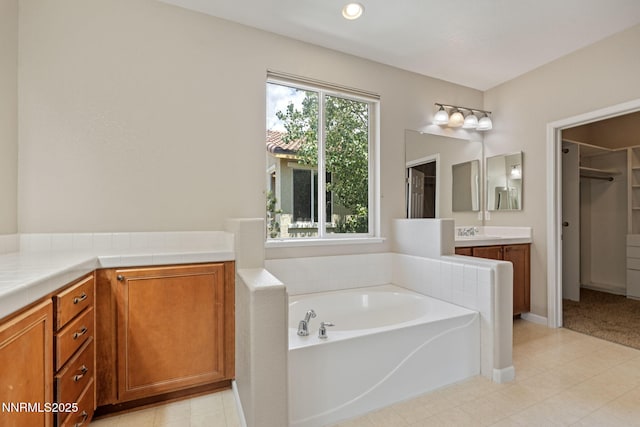7121 Jermann Dr, Sparks, NV 89436 - full bathroom featuring vanity, a bath, a spacious closet, and tile patterned floors