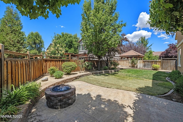 7121 Jermann Dr, Sparks, NV 89436 - fenced backyard with a fire pit and a patio area