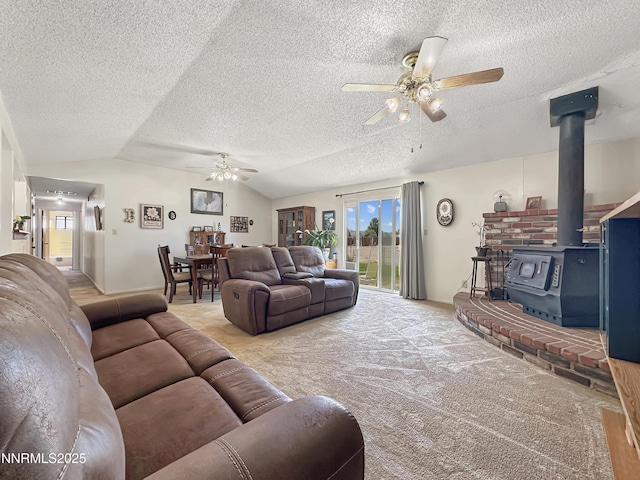 1331 Stephanie Way, Minden, NV 89423 - living room with ceiling fan, a wood stove, lofted ceiling, a textured ceiling, and carpet