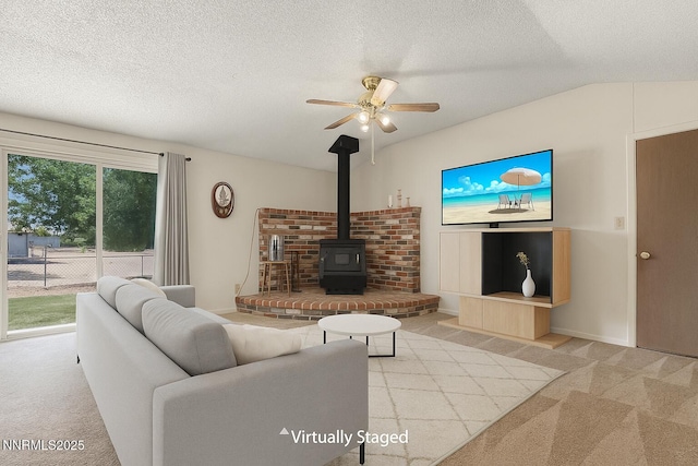 1331 Stephanie Way, Minden, NV 89423 - carpeted living room featuring a ceiling fan, a wood stove, and a textured ceiling