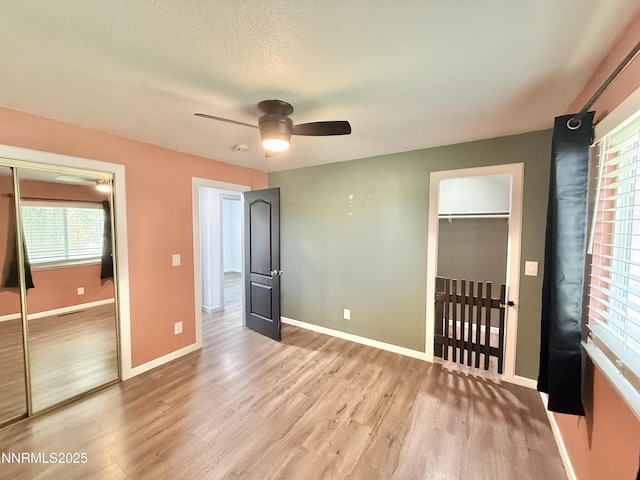 603 Camelot Way, Winnemucca, NV 89445 - unfurnished bedroom featuring a closet, light wood-style flooring, baseboards, and a ceiling fan