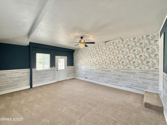 603 Camelot Way, Winnemucca, NV 89445 - unfurnished room featuring a wainscoted wall, a textured ceiling, carpet floors, ceiling fan, and wallpapered walls