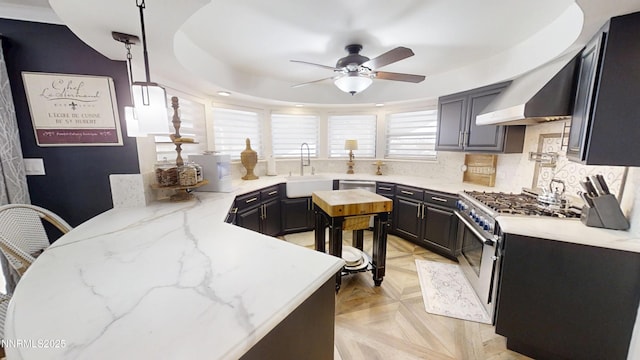 5000 Saint Andrews Dr, Reno, NV 89502 - kitchen with a sink, stainless steel gas stove, ceiling fan, light stone countertops, and backsplash