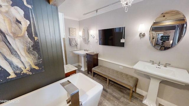 5000 Saint Andrews Dr, Reno, NV 89502 - bathroom with a freestanding bath, wood finished floors, baseboards, crown molding, and a sink