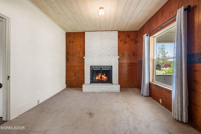 1185 Truckee Ln, Fernley, NV 89408 - unfurnished living room featuring carpet flooring, wood walls, a fireplace, and wood ceiling