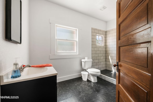 1185 Truckee Ln, Fernley, NV 89408 - full bathroom with toilet, vanity, tiled shower, and baseboards