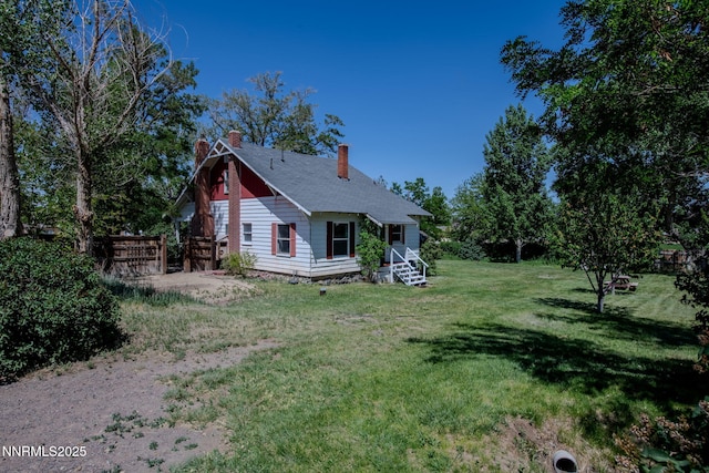 1185 Truckee Ln, Fernley, NV 89408 - rear view of property featuring a chimney and a lawn