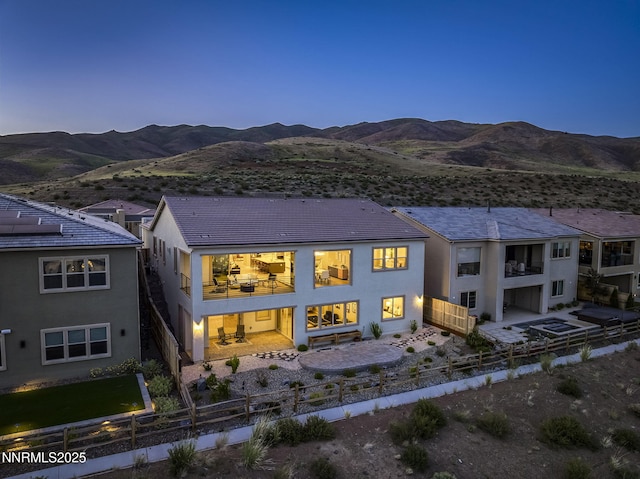 9192 Graycliff Ln, Reno, NV 89523 - back of house with a fenced backyard, a balcony, a mountain view, and stucco siding