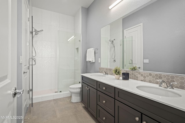 9192 Graycliff Ln, Reno, NV 89523 - bathroom featuring double vanity, a stall shower, toilet, and backsplash