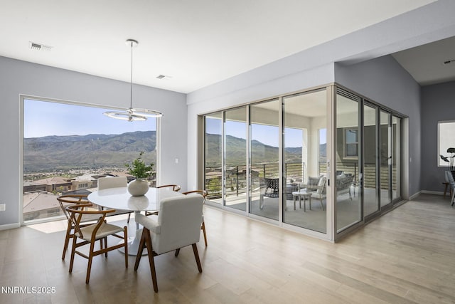 9192 Graycliff Ln, Reno, NV 89523 - dining room featuring a mountain view, wood finished floors, and a chandelier