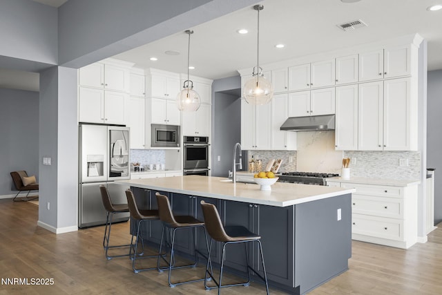 9192 Graycliff Ln, Reno, NV 89523 - kitchen featuring appliances with stainless steel finishes, under cabinet range hood, a sink, recessed lighting, and backsplash