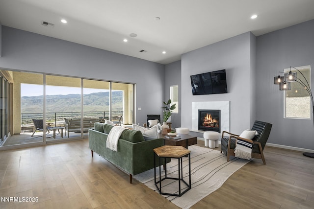 9192 Graycliff Ln, Reno, NV 89523 - living room featuring a mountain view, wood finished floors, recessed lighting, a fireplace, and baseboards
