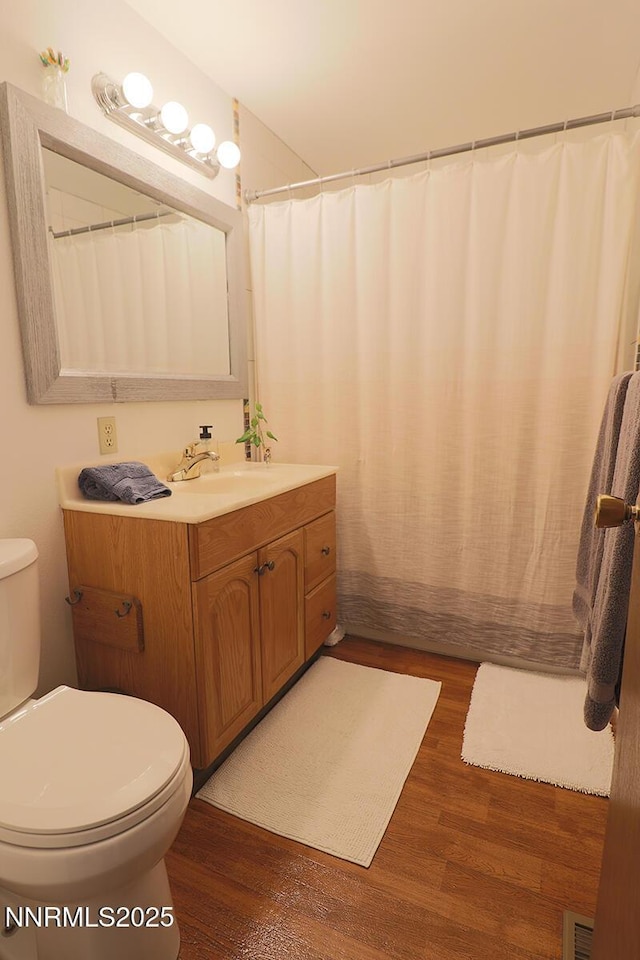 3191 Crescent Ct, Sparks, NV 89431 - full bath with toilet, wood finished floors, vanity, and a shower with curtain