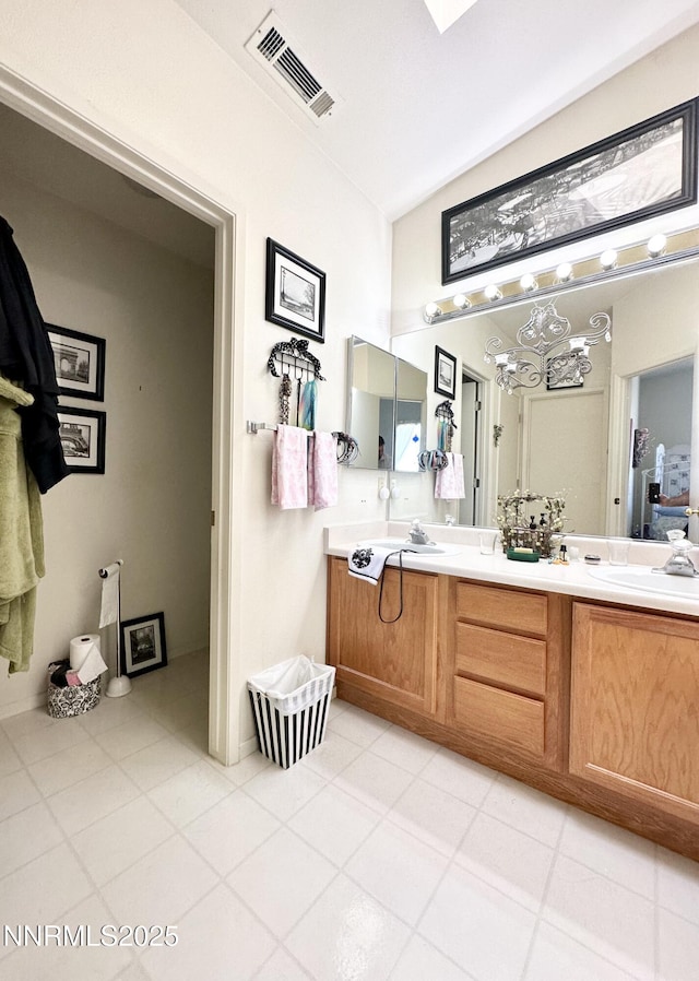 1171 White Oak Loop, Minden, NV 89423 - bathroom featuring double vanity, tile patterned flooring, and vaulted ceiling