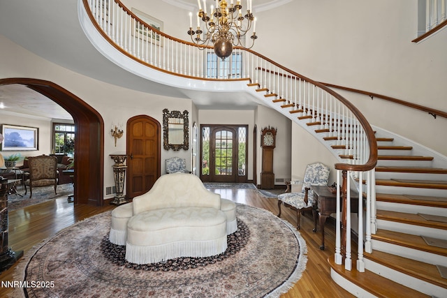 745 California Ave, Reno, NV 89509 - foyer entrance with stairway, ornamental molding, wood finished floors, a high ceiling, and arched walkways