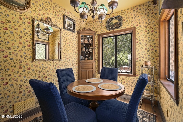 745 California Ave, Reno, NV 89509 - dining space with a chandelier, wallpapered walls, and wood finished floors