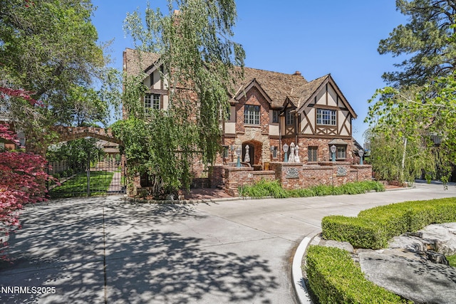 745 California Ave, Reno, NV 89509 - tudor-style house with stucco siding and a gate