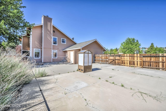 285 Lemming Dr, Reno, NV 89523 - rear view of property with a patio, a storage unit, a fenced backyard, and a chimney