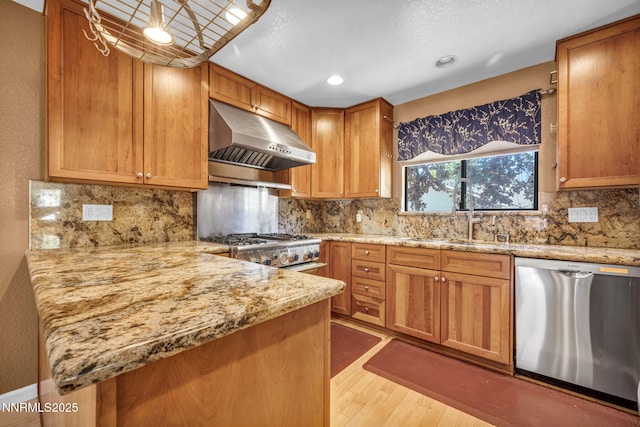 285 Lemming Dr, Reno, NV 89523 - kitchen with stainless steel dishwasher, under cabinet range hood, wood finished floors, light stone countertops, and recessed lighting