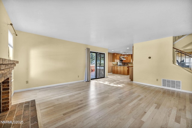 285 Lemming Dr, Reno, NV 89523 - unfurnished living room featuring a fireplace, light wood-style flooring, and recessed lighting