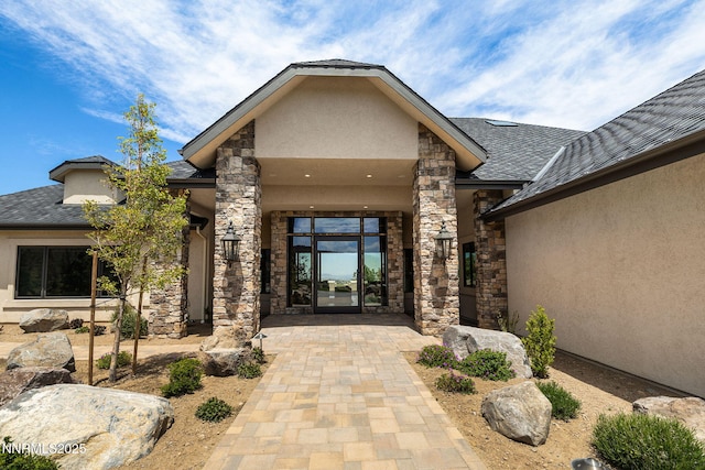 29 Bennington Ct, Reno, NV 89511 - view of exterior entry featuring stucco siding, stone siding, and a shingled roof