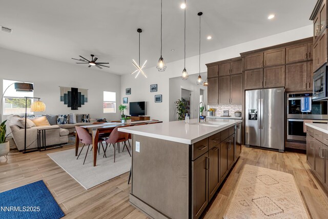 611 Camargue Trl, Reno, NV 89511 - kitchen featuring appliances with stainless steel finishes, light countertops, decorative backsplash, a sink, and recessed lighting