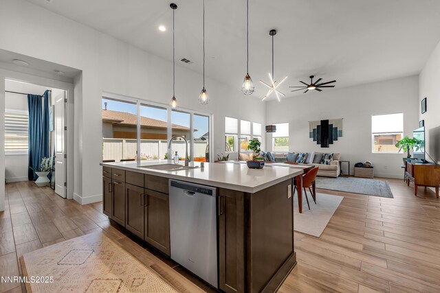 611 Camargue Trl, Reno, NV 89511 - kitchen with stainless steel dishwasher, a sink, dark brown cabinetry, light countertops, and ceiling fan