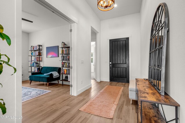 611 Camargue Trl, Reno, NV 89511 - foyer with wood finished floors, a chandelier, and baseboards