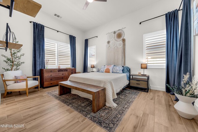 611 Camargue Trl, Reno, NV 89511 - bedroom featuring multiple windows, light wood-style flooring, and baseboards