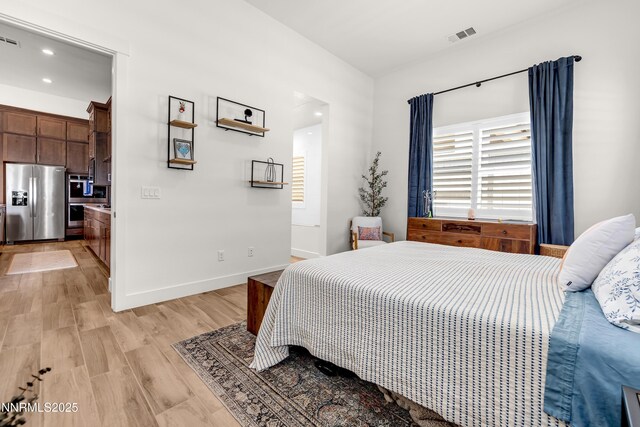 611 Camargue Trl, Reno, NV 89511 - bedroom featuring stainless steel refrigerator with ice dispenser, light wood finished floors, baseboards, and recessed lighting