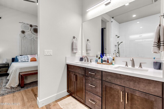 611 Camargue Trl, Reno, NV 89511 - ensuite bathroom with double vanity, wood finished floors, baseboards, tiled shower, and recessed lighting