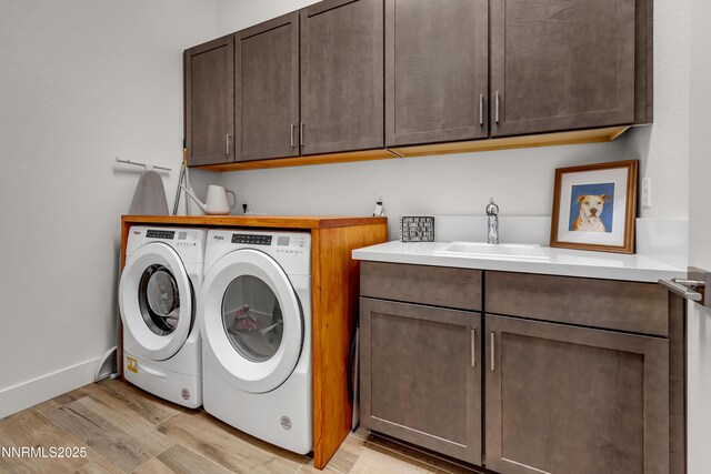 611 Camargue Trl, Reno, NV 89511 - laundry room with separate washer and dryer, cabinet space, light wood-style floors, and baseboards