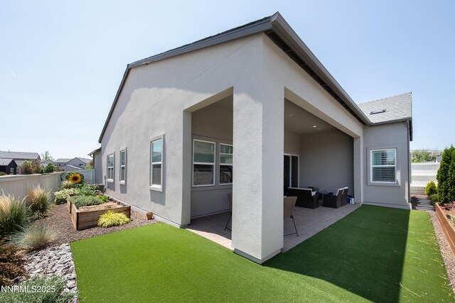 611 Camargue Trl, Reno, NV 89511 - back of house featuring stucco siding, a garden, a patio area, and outdoor lounge area