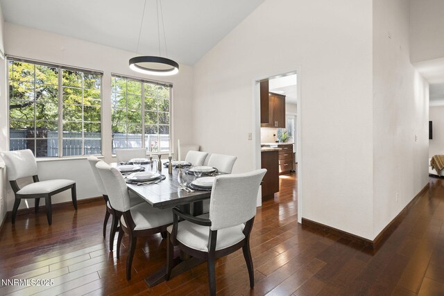 6055 Stonecreek Dr, Reno, NV 89511 - dining area with dark wood-style flooring and high vaulted ceiling
